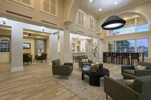 a large living room with couches and chairs